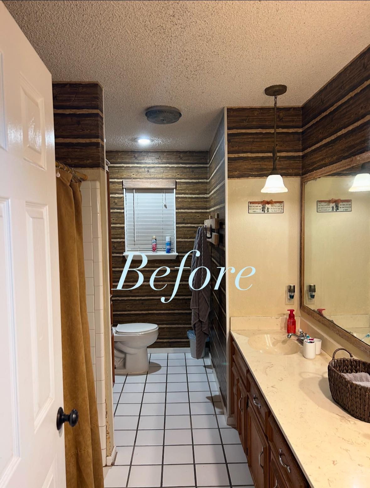 Bathroom before remodel with wood paneling and old tile floor