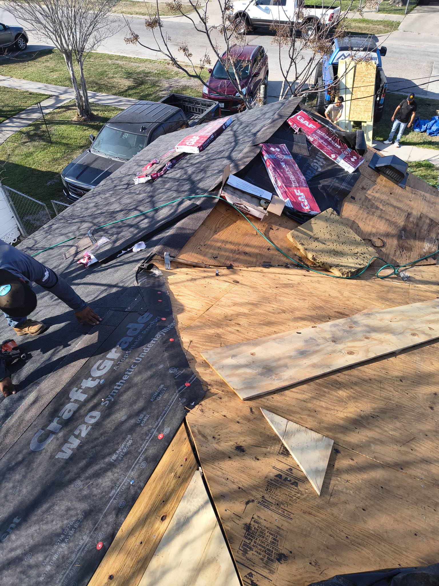 Residential roof installation with new shingles and underlayment in progress