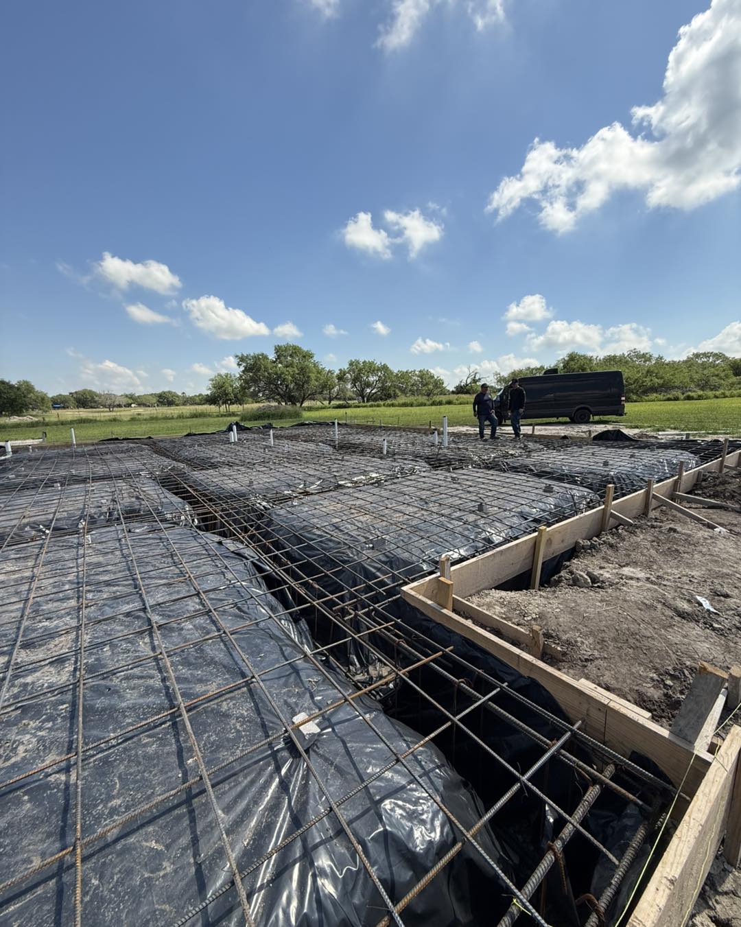 Foundation prep with rebar grid and forms ready for concrete pour