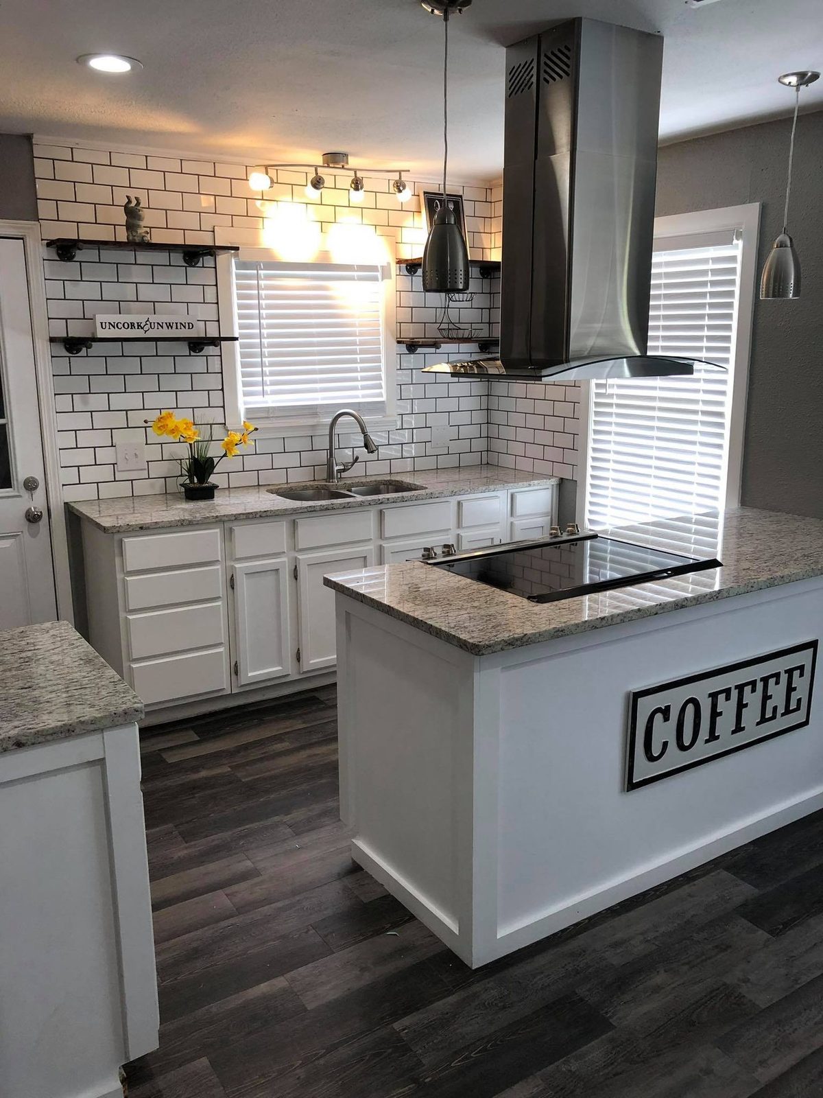 White kitchen with subway tile backsplash, open shelving, and coffee bar island