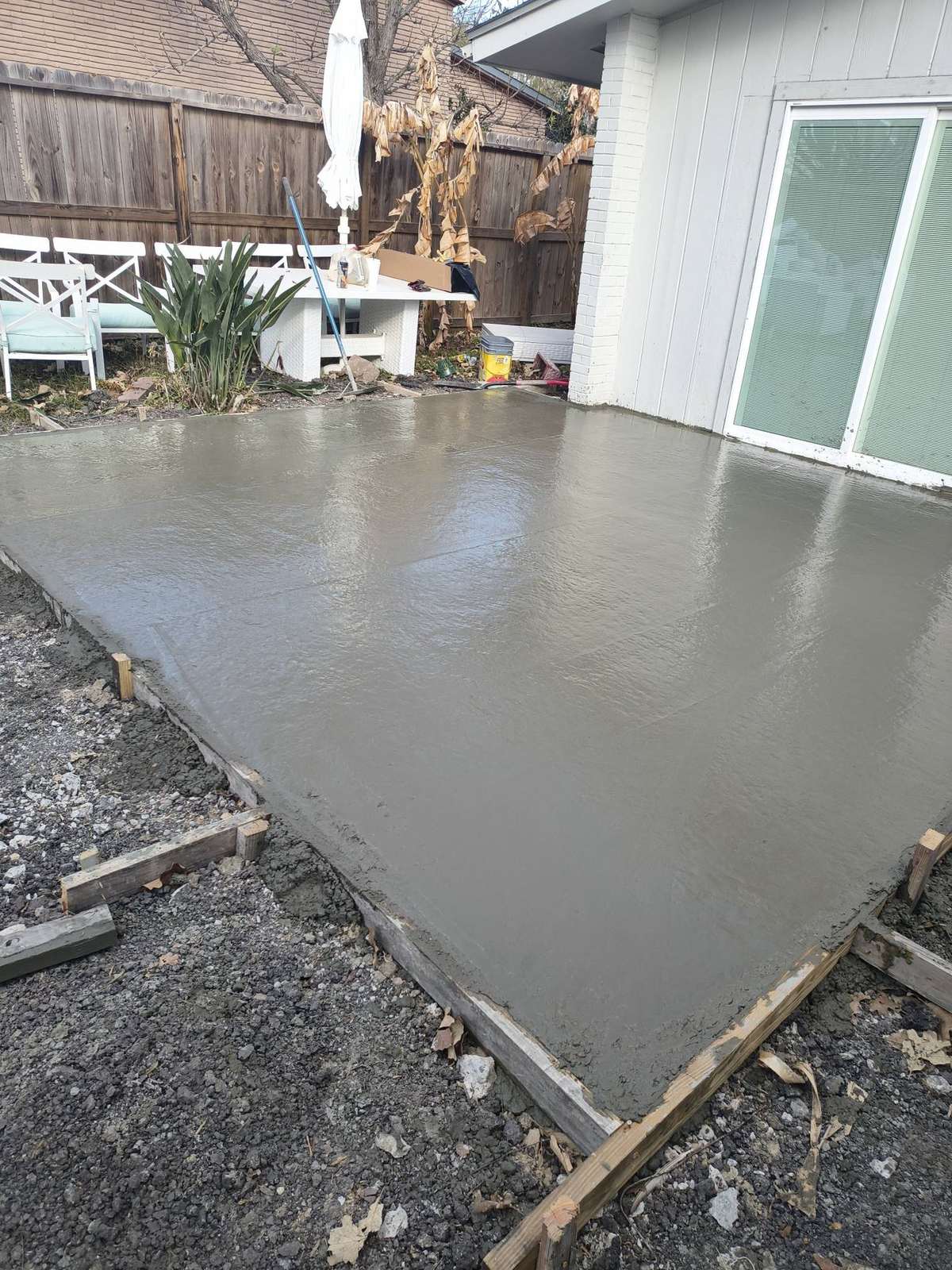 Finished concrete patio slab beside a residential home