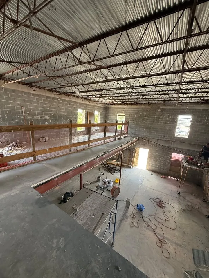 Existing mezzanine and steel beam structure prior to buildout