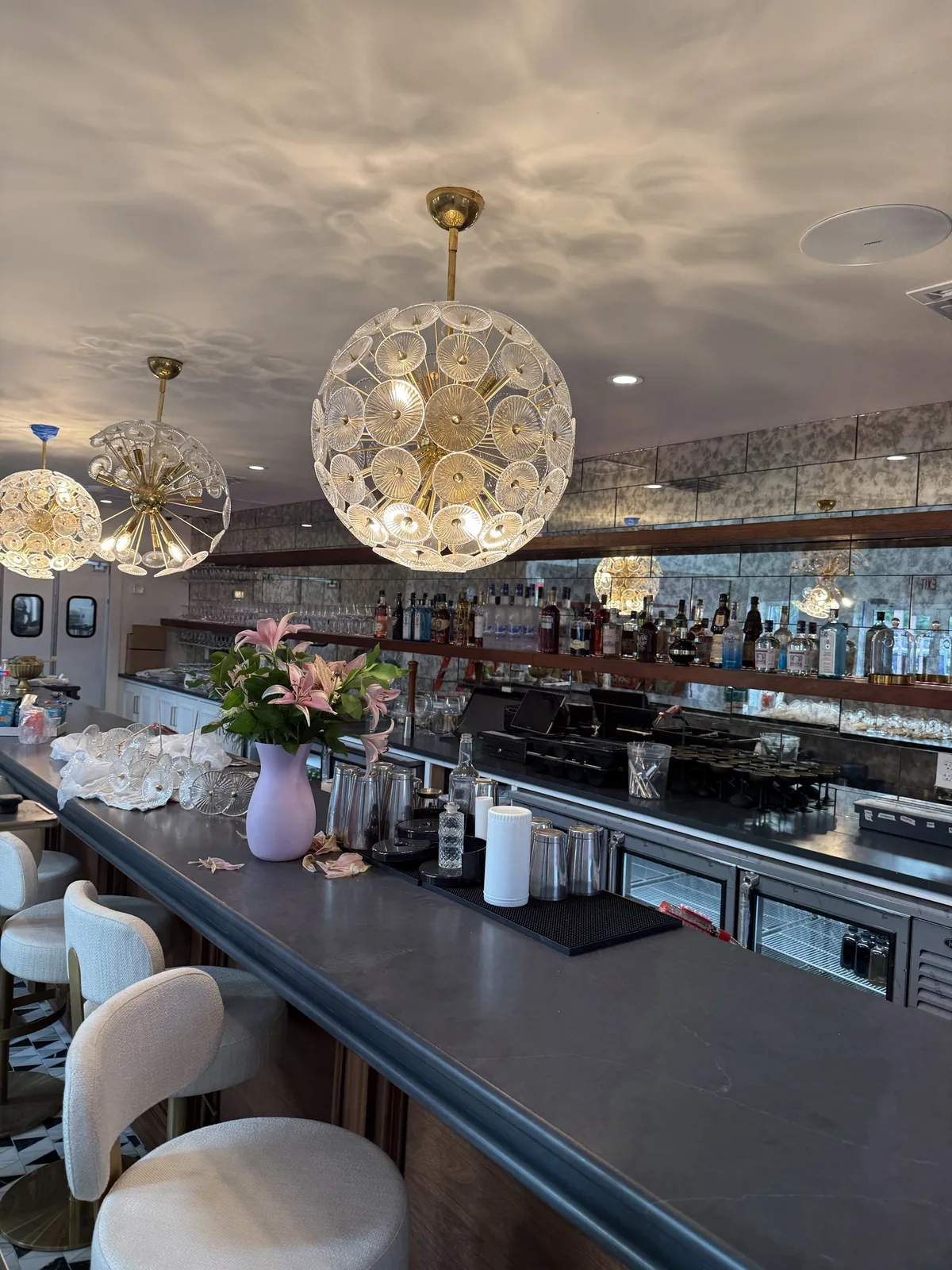 Finished bar with brass sputnik pendants and antique mirrored backbar
