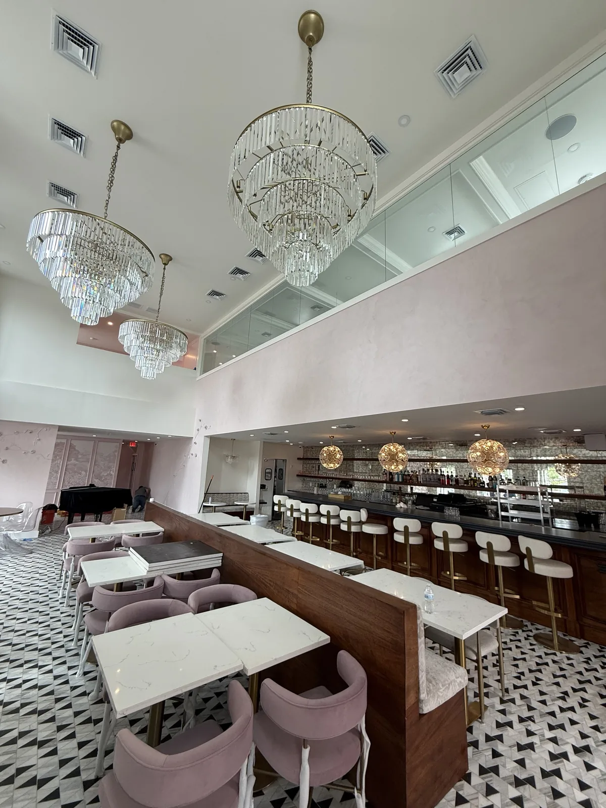 Main dining room with crystal chandeliers, walnut partition and marble floor