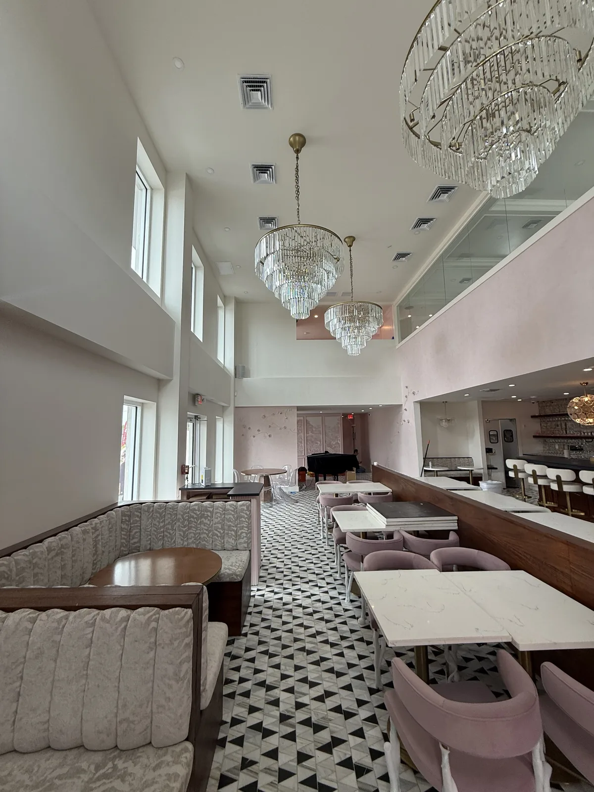 Custom channel-tufted banquette seating in double-height dining room