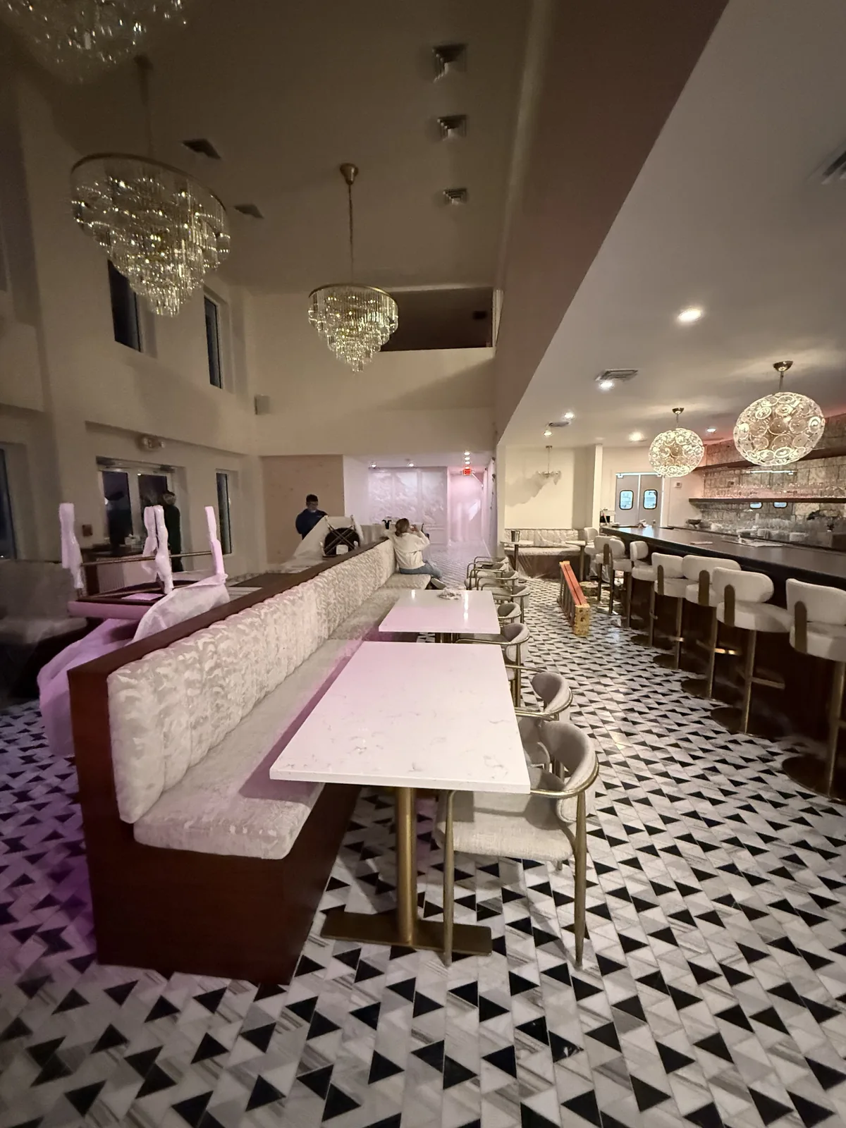 Dining room and bar at night with chandelier lighting