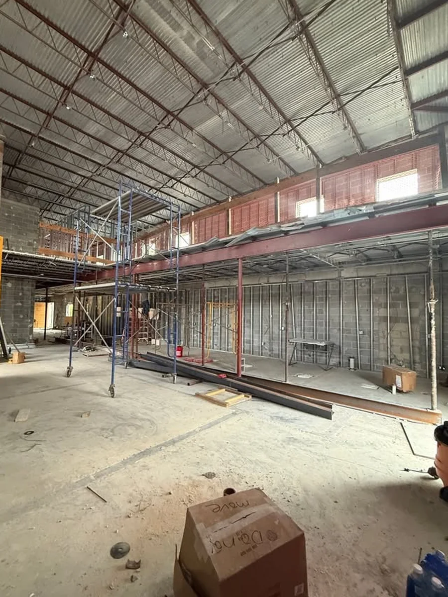 Gutted shell with exposed steel joists, CMU walls and unfinished mezzanine